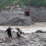 Trading food for medicine and crossing the river by zip line are part of life in Nepal flood zone