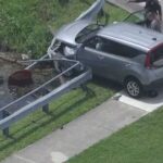 Driver crashes into guardrail at canal in Davie